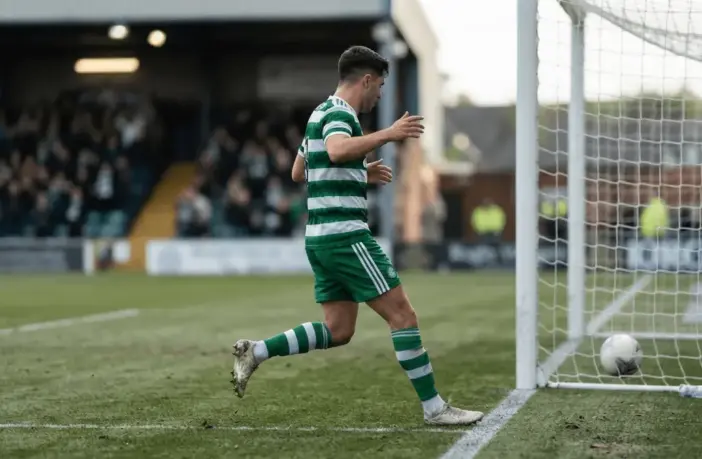 Anonymous Celtic-inspired striker celebrates a decisive penalty-box finish under stadium lights