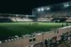 Empty stadium after Celtic’s Champions League exit, with green-and-white supporter colours under night floodlights