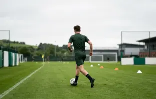 Young football defender training at a professional academy ground as Celtic seek left-back cover