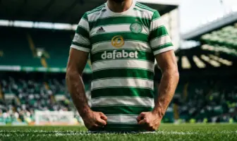 Celtic player in green and white hooped jersey standing ready at Celtic Park stadium