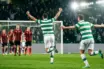 Celtic-style striker celebrates a decisive volley in a floodlit European play-off match