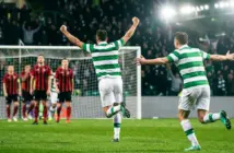 Celtic-style striker celebrates a decisive volley in a floodlit European play-off match