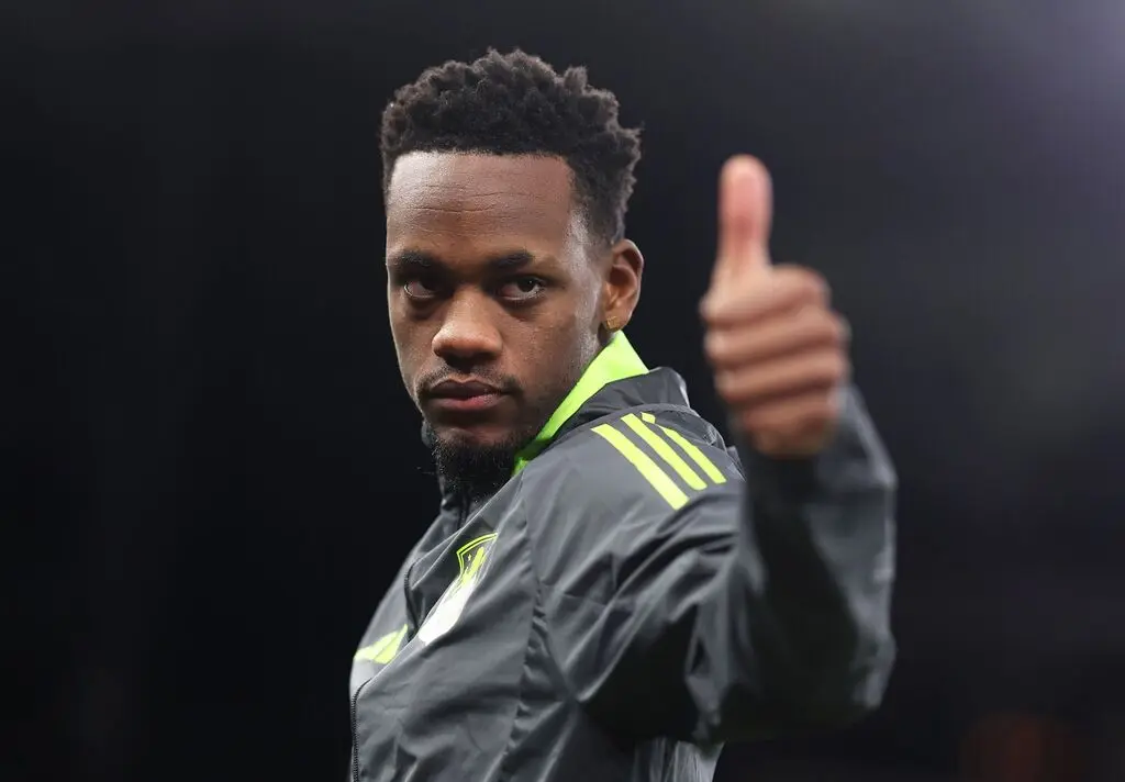 Jhon Durán giving a thumbs up while wearing a grey and lime green athletic jacket