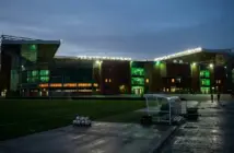 Celtic Park at dusk representing the debate between European ambition and financial caution after the LASK exit