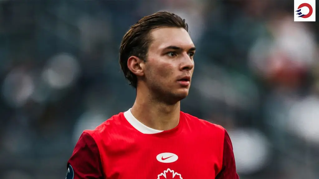 Niko Sigur wearing a red Canada national team soccer jersey during a match.