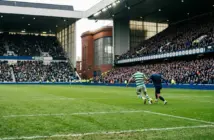 Wide Ibrox Stadium scene capturing the tense Old Firm League Cup derby between Celtic and Rangers.