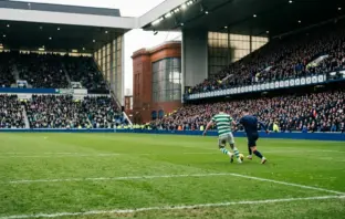 Wide Ibrox Stadium scene capturing the tense Old Firm League Cup derby between Celtic and Rangers.