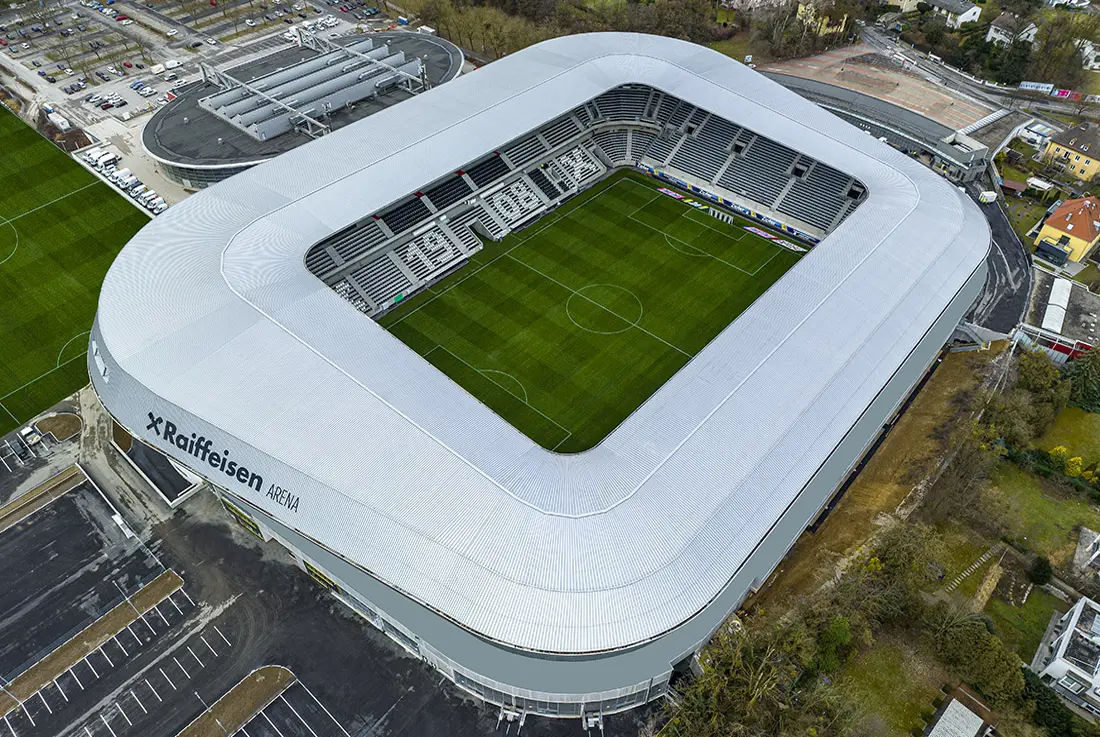 Aerial view of the Raiffeisen Arena Linz soccer stadium with a white roof and green pitch