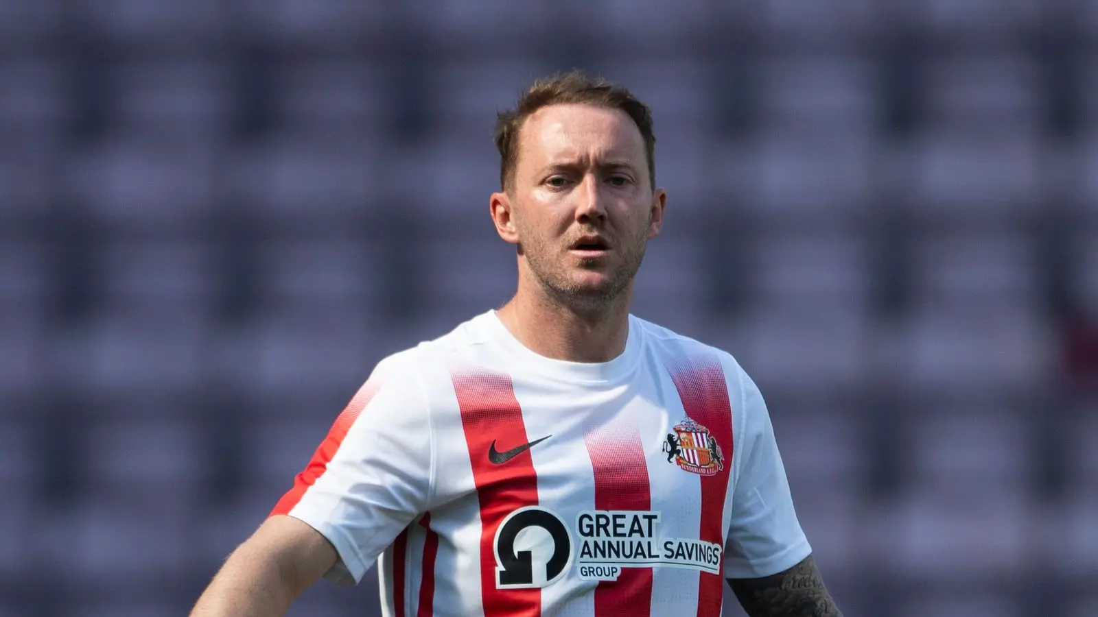 Aiden McGeady wearing a red and white striped Sunderland AFC jersey