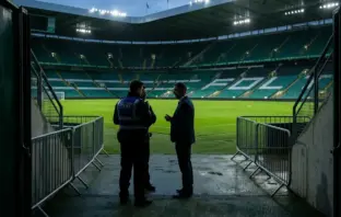 Police and football officials meet near a stadium tunnel before a tense Celtic and Rangers derby