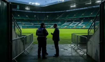 Police and football officials meet near a stadium tunnel before a tense Celtic and Rangers derby