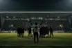Anonymous Celtic player celebrates a hard-fought 1-0 away win under stadium floodlights