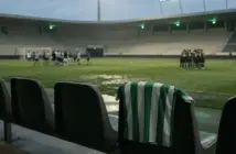 Empty football stadium bench with a green-and-white shirt after a defeat