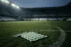 Abandoned green-and-white football shirt on a stadium pitch before a tense derby