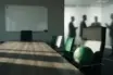 Empty boardroom table and football symbolise Celtic's squad crisis and recruitment failures.