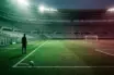 Football transfer dispute symbolised by a midfielder silhouette between green and burgundy stadium light