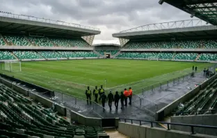 Empty football stadium with police and barriers after title-day disorder at Celtic Park