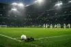 Empty left wing on a floodlit football pitch symbolising Celtic's squad depth test without Yang Hyun-jun