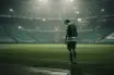 Anonymous Celtic-inspired player standing alone under stadium lights after a derby defeat