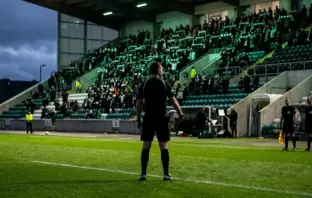 Anonymous match officials prepare on the pitch at McDiarmid Park before Celtic’s rearranged fixture in Perth.