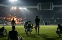 Exhausted Celtic-inspired players react after a dramatic European football collapse under stadium lights