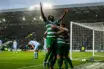 Celtic-inspired players celebrate a dramatic comeback victory in a rain-lit stadium